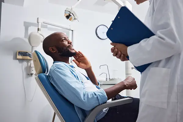 A patient sitting in the dentist chair awaiting an exam